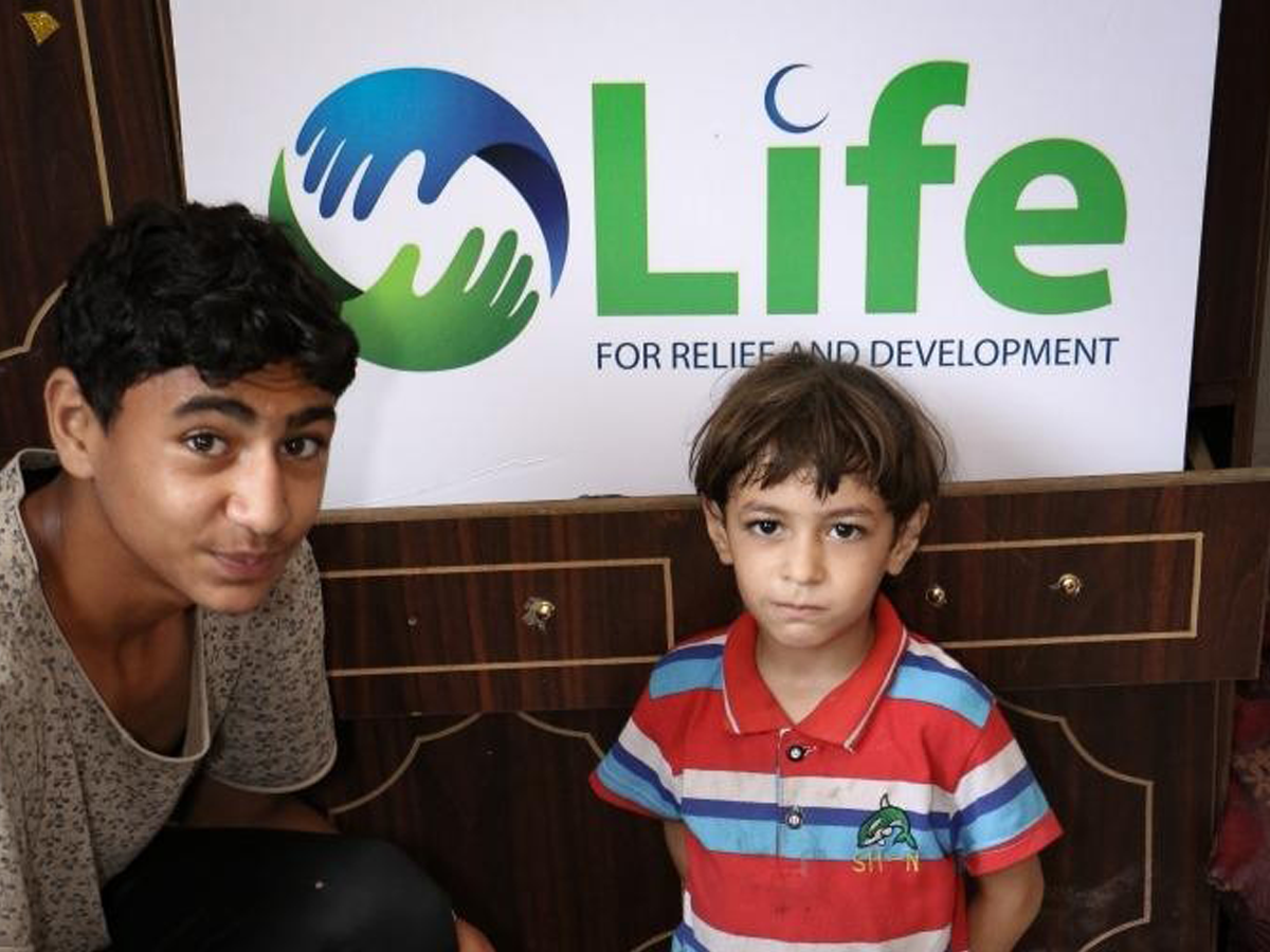 Community members with Life for Relief banner